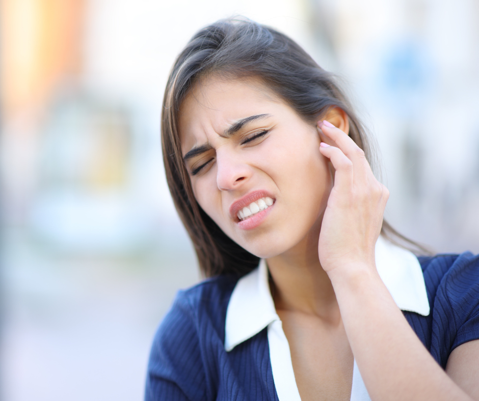 Woman experiencing ear problems