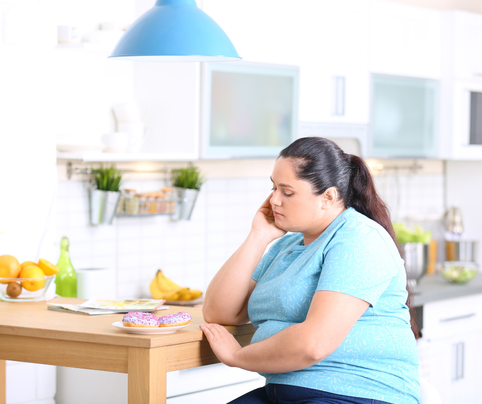 Sad Overweight Woman with Donuts in Kitchen. Failed Diet